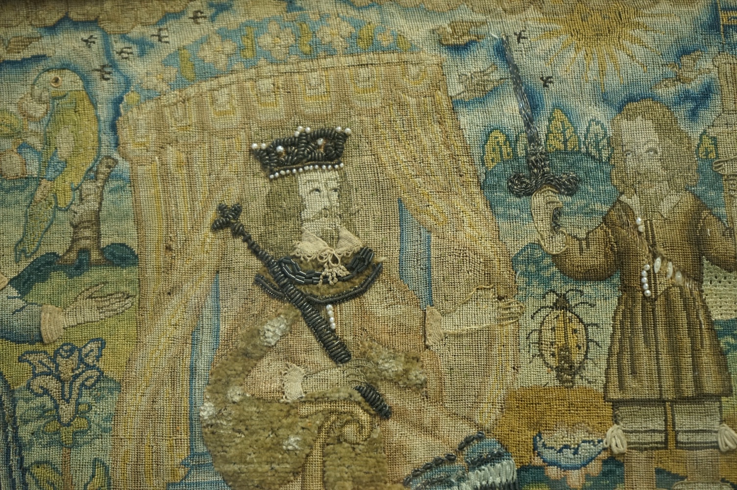 An 17th century petit point embroidered panel housed in a tortoise shell and gilt frame. The embroidery depicting Charles I, within a tent, with Henrietta Maria looking at a gentleman dangling a boy in one hand and sword